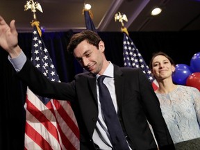 Democratic candidate for 6th congressional district Jon Ossoff, left, waves to the crowd while stepping offstage with his fiancee Alisha Kramer after conceding to Republican Karen Handel at his election night party in Atlanta, Tuesday, June 20, 2017. (AP Photo/David Goldman)