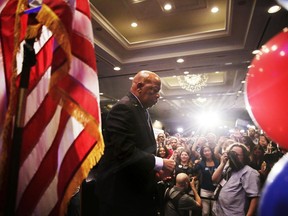 Rep. John Lewis, D-Ga., left, walks offstage after speaking at an election night party for Democratic candidate for 6th Congressional District Jon Ossoff in Atlanta, Tuesday, June 20, 2017. (AP Photo/David Goldman)