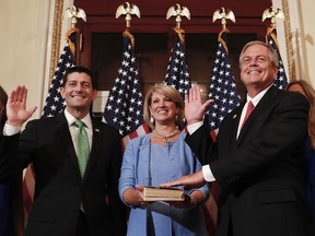Speaker of the House Paul Ryan, R-Wis., left, Representative-elect Ralph Norman, R-S.C., right and his wife Elaine Rice Norman, center, participate in a ceremonial swearing-in on Capitol Hill in Washington, Monday, June 26, 2017. Norman, a staunch conservative, had a 3 percentage point victory last week in a South Carolina race in a district that went for President Donald Trump last year by 18 percentage points. (AP Photo/Carolyn Kaster)
