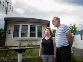 Residents Marc Patry and his wife Louise Landry outside their home in Ile Bizard