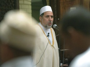 In this June 15, 2005 file photo, Imam Shaker Elsayed delivers the sermon at prayers services at the Dar al-Hijra mosque in Falls Church, Va.