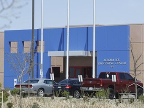 In this Saturday, April 15, 2017, photograph, the entrance to the GEO Group's immigrant detention facility is shown in Aurora, Colo. People once held in a privately run Colorado immigration detention center are challenging the system used to keep it clean and maintained, arguing it borders on slavery. They have won the right to sue GEO Group on behalf of an estimated 60,000 people held at its detention center near Denver over a decade. (AP Photo/David Zalubowski)