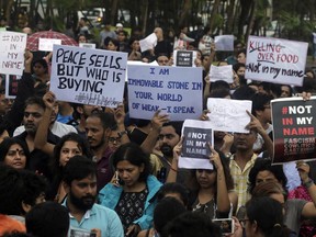 Protestors hold placards against a spate of violent attacks across the country targetting the country's Muslim minority, in Mumbai, India, Wednesday, June 28, 2017. Carrying placards that said "not in my name," the protestors on Wednesday decried the silence of India's Hindu rightwing government in the face of the public lynchings and violent attacks on at least a dozen Muslim men and boys since it came to power in 2014. (AP Photo/Rafiq Maqbool)