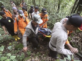Rescuers carry the body of German hiker Wolter Klaus as they walk down a trail at Mount Sibayak in Karo, North Sumatra, Indonesia, Friday, June 30, 2017. Klaus was reported missing last week while hiking on the dormant volcano. (AP Photo/Binsar Bakkara)