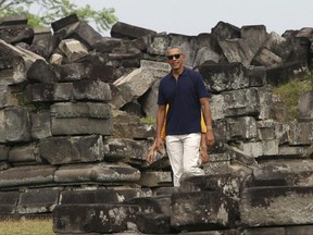 Former U.S. President Barack Obama walks during his visit to Prambanan Temple in Yogyakarta, Indonesia, Thursday, June 29, 2017