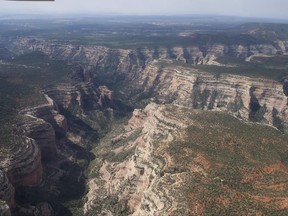 FILE - This May 8, 2017, file photo shows an aerial view of Arch Canyon within Bears Ears National Monument in Utah. Native American tribes and environmental groups preparing a legal battle to stop President Donald Trump from dismantling Utah's new national monument will face a tougher challenge than anticipated. (Francisco Kjolseth/The Salt Lake Tribune via AP, File)