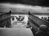 American troops from the USS Samuel Chase wade into the water during the initial landing at Normandy on the morning of June 6, 1944.