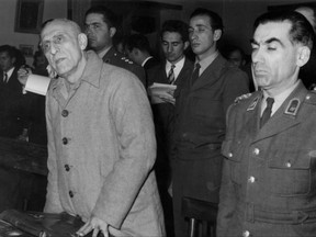 FILE- In this Dec. 21, 1953 file photo, former Iranian Prime Minister Mohammed Mosaddegh, left, is sentenced to three years solitary confinement by a military court after findidng him guilty on 13 charges of acting against the Shah, in Tehran, Iran. Once expunged from its official history, documents outlining the U.S.-backed 1953 coup in Iran have been quietly published in June 2017, by the State Department, offering a new glimpse at an operation that ultimately pushed the country toward its 1979 Islamic Revolution and hostility with the West. (AP Photo, File)