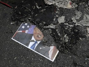 A portrait of U.S. President Donald Trump burned by Iranian demonstrators lies on the ground in their annual pro-Palestinian rally marking Al-Quds (Jerusalem) Day in Tehran, Iran, Friday, June 23, 2017. Iran held rallies across the country, with protesters condemning Israel's occupation of Palestinian territories and chanting "Death to Israel." (AP Photo/Vahid Salemi)