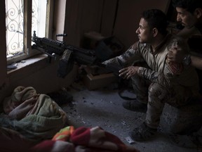 Iraqi special forces soldiers watch Islamic State positions at the frontline near the al-Nuri mosque in the Old City of Mosul, Iraq, Wednesday, June 28, 2017. (AP Photo/Felipe Dana)