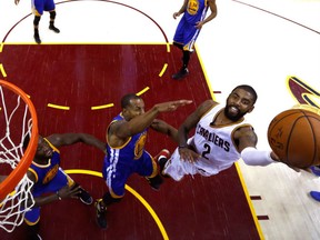 Kyrie Irving of the Cleveland Cavaliers drives to the basket to score two of his game-high 40 points in Friday's Game 4 of the NBA Finals in Cleveland. Irving's heroics helped the Cavs post a 137-166 victory and extend the series to a fifth game Monday night in Oakland. Warriors still lead the series 3-1.