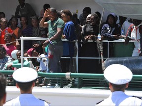 Migrants wait to disembark from the Spanish ship 'Rio Segura' in the harbor of Salerno, Italy, Thursday,  June 29, 2017. Over 1200 migrants, including children, were rescued while attempting to cross the Mediterranean. The European Union's foreign minister says the bloc supports Italy's stance that it can no longer handle the flood of migrants alone, and she insists other EU countries share the burden.  (Ciro Fusco/ANSA via AP)