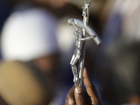A man holds a crucifix