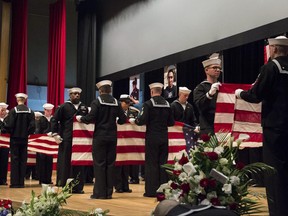 In this photo released by U.S. Navy, sailors fold seven U.S. flags during a memorial ceremony at Fleet Activities (FLEACT) Yokosuka, south of Tokyo, Tuesday, June 27, 2017, for seven sailors assigned to USS Fitzgerald who were killed in the June 17 collision. The U.S. Navy has paid tribute to the sailors killed as their warship collided with a merchant ship off Japan this month. The USS Fitzgerald and the Philippine-flagged container collided in the Japanese waters off Yokosuka in the pre-dawn hours of June 17. (Mass Communication Specialist 2nd Class Raymond D. Diaz III/U.S. Navy via AP)