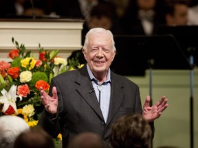In this Aug. 23, 2015, file photo, former President Jimmy Carter teaches Sunday School class at Maranatha Baptist Church in his hometown in Plains, Ga. Video posted online on June 8, 2017, shows Carter shaking the hand of every passenger aboard a recent commercial flight from Atlanta to Washington.
