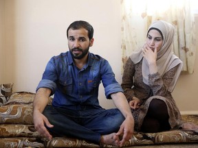 Mohammad al-Haj Ali, 28, and his wife Samah Hamidi, 25, pose for a photo during an interview in their home in Irbid, Jordan on Thursday, June 29, 2017. The family fled the Syrian war in 2012 for Jordan and was in the resettlement pipeline to the U.S. when President Donald Trump's executive order stalled the process. Once sure of his future in the U.S., al-Haj Ali had quit his job, sold the furniture and rented an apartment in the city of Rockford near his uncle's home in Illinois. The family still has five suitcases packed but has scant hope for resettlement in America. (AP Photo/Reem Saad)