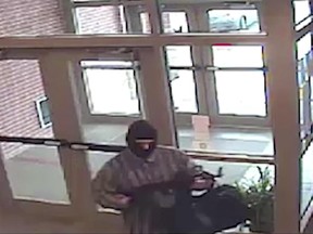 This undated image from surveillance video released by the FBI shows the suspect known as the AK-47 Bandit. Federal agents found homemade bombs in the Montana home of Richard Gathercole, a man they suspect is the "AK-47 Bandit," who is wanted for a string of bank robberies and is accused of shooting at a Kansas state trooper, according to authorities and court documents filed Monday, June 26, 2017. (FBI via AP)