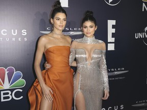 FILE - In this Jan. 8, 2017 file photo, Kendall Jenner, left, and Kylie Jenner arrive at the NBCUniversal Golden Globes afterparty at the Beverly Hilton Hotel in Beverly Hills, Calif. Kendall and Kylie Jenner apologized Thursday, June 29, 2017, for "vintage" T-shirts superimposing their images with those of famous musicians, including Ozzy Osbourne, Tupac and the Notorious B.I.G. The sisters began selling the shirts Wednesday online for $125 each as part of their Kendall + Kylie brand. (Photo by Rich Fury/Invision/AP, File)