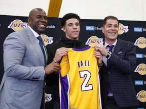Los Angeles Lakers' Lonzo Ball, center, poses for photos with Magic Johnson, left, and general manager Rob Pelinka during a news conference, Friday, June 23, 2017, in El Segundo, Calif. (AP Photo/Jae C. Hong)