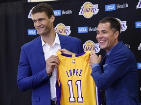 Brook Lopez, left, a new member of the Los Angeles Lakers, holds up his jersey with Lakers general manager Rob Pelinka during a news conference at Toyota Sports Center in El Segundo, Calif., on Wednesday, June 28, 2017. (AP Photo/Chris Pizzello)