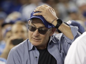 FILE - In this Oct. 19, 2016, file photo, actor Charlie Sheen reacts during the fifth inning of Game 4 of the National League baseball championship series between the Chicago Cubs and the Los Angeles Dodgers in Los Angeles. Sheen hasn't portrayed Babe Ruth in a film, but the actor was the owner of two of the most prized items of Ruth memorabilia. Sheen on Monday, June 26, 2017 revealed himself as the owner of Ruth's 1927 World Series ring and the 1919 contract of Ruth's sale from the Red Sox to the Yankees which are part of the first Lelands.com Invitational Auction, which ends on Friday. (AP Photo/David J. Phillip, File)