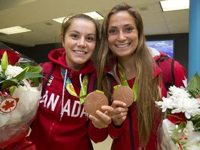 Canadian soccer players Jessie Fleming and Shelina Zadorsky show off their Olympic bronze medals upon arriving back in Canada after the 2016 Olympics in Rio de Janeiro.