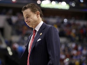 FILE - In this March 19, 2017, file photo, Louisville head coach Rick Pitino walks off the court after a 73-69 loss to Michigan in a second-round game in the men's NCAA college basketball tournament in Indianapolis. Louisville and coach Pitino are awaiting discipline from the NCAA on Thursday, June 15, 2017, regarding a sex scandal that engulfed the men's basketball program. A former men's basketball staffer is alleged to have hired strippers to entertain players and recruits.  (AP Photo/Jeff Roberson, File)