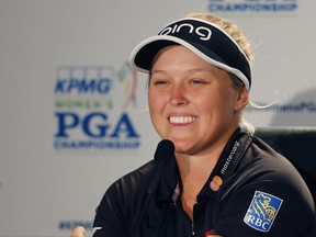 Brooke Henderson smiles as she fields questions from reporters during the practice round of the Women's PGA Championship golf tournament at Olympia Fields Country Club, Wednesday, June 28, 2017, in Olympia Fields, Ill. (AP Photo/Charles Rex Arbogast)
