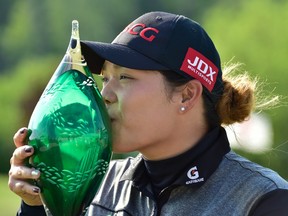 Ariya Jutanugarn kisses the LPGA Classic winner's trophy on June 11.