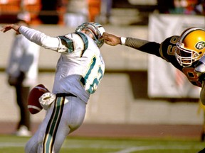 In this Oct. 29, 1994 file photo, Edmonton Eskimos DE Leroy Blugh (right) grabs hold of Sacramento Gold Miners QB Kerwin Bell's face mask.