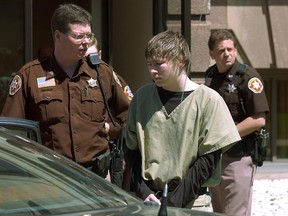 FILE - In a May 4, 2006 file photo, Brendan Dassey, center, is lead out of the Manitowoc County Courthouse following his motion hearing in Manitowoc, Wis. A three-judge panel from the 7th Circuit on Thursday, June 22, 2017 affirmed that Dassey, a Wisconsin inmate featured in the Netflix series "Making a Murderer" was coerced into confessing and should be released from prison. Dassey was sentenced to life in prison in 2007 in photographer Teresa Halbach's death two years earlier.  (Eric Young/Herald-Times Reporter via AP, File)