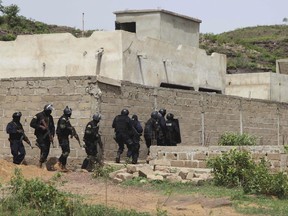 Malian Police officers take position outside Campement Kangaba, a tourist resort near Bamako, Mali, Monday, June. 19, 2017. Authorities in Mali say the death toll has risen following a terror attack on a luxury resort area popular with foreigners in Mali's capital. (AP Photo/Baba Ahmed)