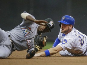 Milwaukee Brewers' Travis Shaw is tagged out by Miami Marlins' Dee Gordon during the fourth inning of a baseball game Friday, June 30, 2017, in Milwaukee. (AP Photo/Tom Lynn)