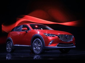FILE - In this Nov. 19, 2014, file photo, the 2016 Mazda CX-3 is unveiled at the Los Angeles Auto Show, in Los Angeles. Mazda is recalling nearly 228,000 cars in the U.S. because the parking brake may not fully release or could fail to hold the cars, increasing the risk of a crash. The recall covers certain Mazda 6 cars from the 2014 and 2015 model years and the Mazda 3 from 2014 through 2016. (AP Photo/Jae C. Hong, File)