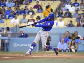 New York Mets' Curtis Granderson, left, hits a solo home run as Los Angeles Dodgers catcher Yasmani Grandal watches during the first inning of a baseball game, Wednesday, June 21, 2017, in Los Angeles. (AP Photo/Mark J. Terrill)