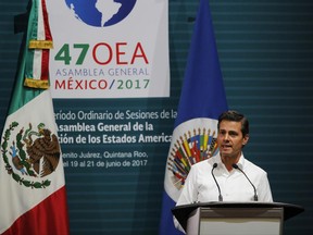 Mexico's President Enrique Pena Nieto speaks during the opening of the 2017 General Assembly of the Organization of American States in Cancun, Mexico, Monday, June 19, 2017. Venezuela's foreign minister walked out of a meeting of regional diplomats to discuss the South American country's political crisis on Monday as a 17-year-old anti-government demonstrator was shot and killed during clashes with security forces. The OAS meeting once again narrowly failed to approve a resolution that would have pushed back against some of Venezuelan President Nicolas Maduro's most radical actions.(AP Photo/Israel Leal)