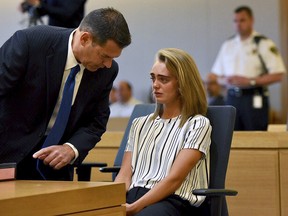 Attorney Joseph Cataldo talks to his client, Michelle Carter, at the beginning of the court session at Taunton Juvenile Court in Taunton, Mass., on Monday, June 5, 2017. Carter is charged with manslaughter for sending her boyfriend text messages encouraging him to kill himself.