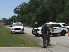 Authorities block an entrance to Redstone Arsenal, Tuesday, June 27, 2017, in Huntsville, Ala. The military post said in a tweet it was on lockdown Tuesday amid reports of possible active shooter, telling workers to "run hide fight." More than 30,000 government employees, civilians and contractors work daily at Redstone. It is home to Army missile defense programs and other military offices. (AP Photo/Eric Schultz)