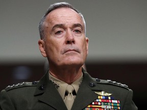 FILE - In this June 13, 2017, file photo. Joint Chiefs Chairman Gen. Joseph Dunford listens on Capitol Hill in Washington. Military chiefs will seek a six-month delay before letting transgender people enlist in their services, officials said June 23. Dunford told a Senate committee there have been some issues identified with recruiting transgender individuals that "some of the service chiefs believe need to be resolved before we move forward." He said Mattis was reviewing the matter. (AP Photo/Jacquelyn Martin, File)