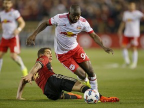 FILE - In this Sunday, March 5, 2017 file photo, New York Red Bulls forward Bradley Wright-Phillips (99) dribbles as Atlanta United midfielder Carlos Carmona (14) defends in the second half of an MLS soccer game in Atlanta. It's Rivalry Week for Major League Soccer with three marquee matchups set for this weekend. The Hudson River Derby between the Red Bulls and NYCFC on Saturday, June 24, 2017 has been grabbing much of the attention.  (AP Photo/Todd Kirkland, File)