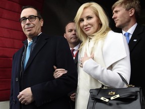 FILE - In this Friday, Jan. 20, 2017, file photo, Treasury Secretary-designate Stephen Mnuchin and his fiancee, Louise Linton, arrive on Capitol Hill in Washington, for the presidential inauguration of Donald Trump. Mnuchin and Linton are to be married Saturday, June 24, 2017. (Saul Loeb/Pool Photo via AP, File)