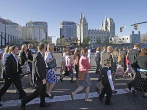 FILE - In this April 4, 2015, file photo, Mormon women wear dresses on their way to the religion's twice-yearly conference in Salt Lake City. Church leaders announced Wednesday, June 28, 2017, that women who work at church headquarters in Salt Lake City can now wear pantsuits or dress slacks instead of only skirts or dresses. Men who work for the church will also now be allowed to remove their suit coats in hot weather. (AP Photo/Rick Bowmer, File)