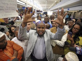 Imam Yussuf Abdi is welcomed home by friends Sunday, June 18, 2017, after he arrives at Salt Lake City International Airport. Abdi, a Utah Muslim leader barred from flying to the U.S. last week finally returned home. Abdi and his attorneys believe his name was on a government no-fly list and that's why he was blocked from returning to the U.S. from Kenya. Abdi was attempting to bring his wife and children to the U.S. but was blocked last week from boarding flights in Kenya and Los Angeles. (AP Photo/Rick Bowmer)