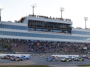 Drivers pass the grandstand at the start of the NASCAR Truck Series auto race, Friday, June 23, 2017, at Iowa Speedway in Newton, Iowa. (AP Photo/Charlie Neibergall)