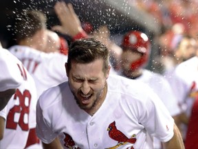St. Louis Cardinals' Paul DeJong is congratulated by a teammate with a splash of water in the face after hitting a two-run home run during the fourth inning of the team's baseball game against the Washington Nationals on Friday, June 30, 2017, in St. Louis. (AP Photo/Jeff Roberson)