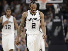 FILE - This May 9, 2017 file photo shows San Antonio Spurs forward Kawhi Leonard (2) walking on the court during the second half of Game 5 in a second-round NBA basketball playoff series against the Houston Rockets in San Antonio. The NBA will announce the winner of the MVP and the other individual honors during the first NBA Awards show in New York. Oklahoma City's Russell Westbrook, Houston's James Harden and San Antonio's Kawhi Leonard are the finalists for MVP of the 2016-17 season. (AP Photo/Eric Gay)