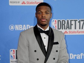 North Carolina State's Dennis Smith poses for photos while walking the red carpet before the start of the NBA basketball draft, Thursday, June 22, 2017, in New York. (AP Photo/Frank Franklin II)