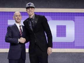 Zach Collins poses for photos with NBA Commissioner Adam silver after being selected by the Sacramento Kings as the 10th pick overall during the NBA basketball draft, Thursday, June 22, 2017, in New York. (AP Photo/Frank Franklin II)