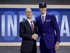 T.J. Leaf poses for photos with NBA Commissioner Adam Silver after being selected by the Indiana Pacers as the 18th pick overall during the NBA basketball draft, Thursday, June 22, 2017, in New York. (AP Photo/Frank Franklin II)