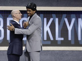 Texas center Jarrett Allen is congratulated by NBA Commissioner Adam Silver after being selected by the Brooklyn Nets as the 22nd pick overall during the NBA basketball draft, Thursday, June 22, 2017, in New York. (AP Photo/Frank Franklin II)